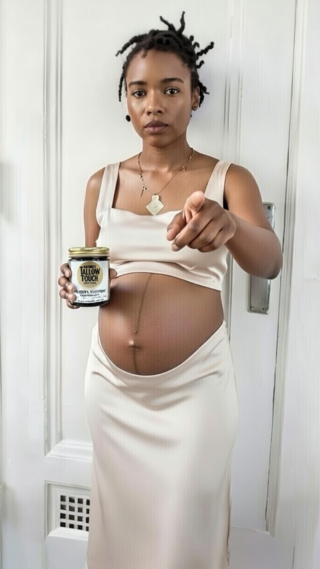  Pregnant woman in Harlem apartment holding Nature’s Tallow Touch Mother’s Recovery Body Cream